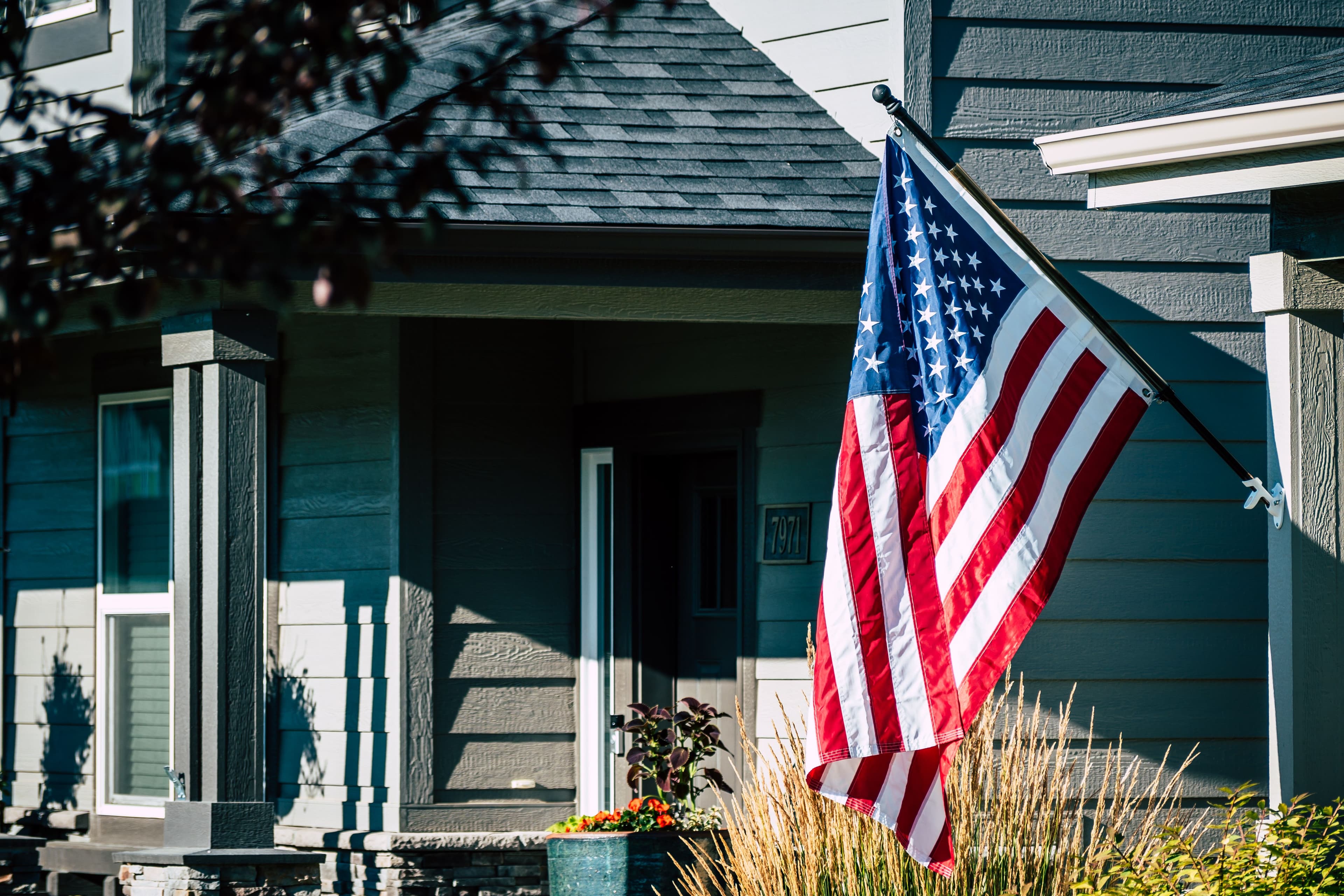 Military family in front of their new home